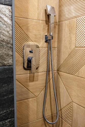 a hose hooked up to a shower in a wall at LUXIMO ROOM in Veliko Tŭrnovo