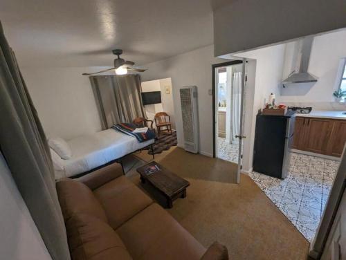 a living room with a couch and a kitchen at Three Pines Cabins in Big Bear Lake