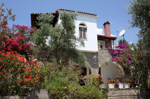 a house with flowers in front of it at Blue Fox 1 in Chrani