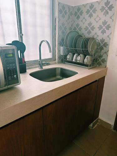 a kitchen counter with a sink and a window at Newly renovated ! Villa Laguna Cancun in Cancún