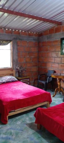 Postel nebo postele na pokoji v ubytování Finca Agroturistica Las Margaritas