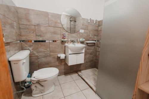 a bathroom with a toilet and a sink at Boulevard Six in General Pico