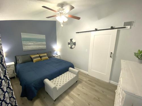 a bedroom with a blue bed and a ceiling fan at B Lakefront! Remodeled, Boat Slip, Patio Views, Pool, Boat Ramp, WIFI in Osage Beach