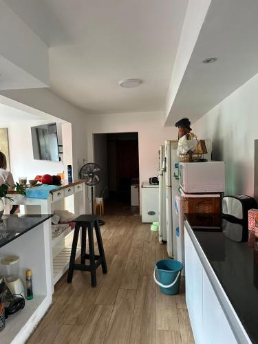a man standing in a kitchen with a refrigerator at Hospedaje posada en Ezeiza in Ezeiza