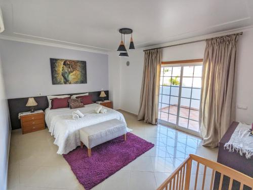 1 dormitorio con cama y alfombra morada en Villa Algarve- Townhouse in Farm Village, Albufeira, en Albufeira