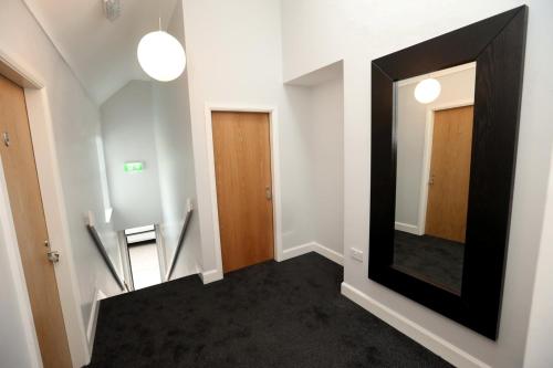 a hallway with a large mirror on the wall at Moran's Bar & B&B in Grange