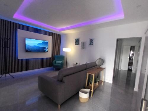 a living room with a couch and a chair at El Ramonal Vacacional in Candelaria