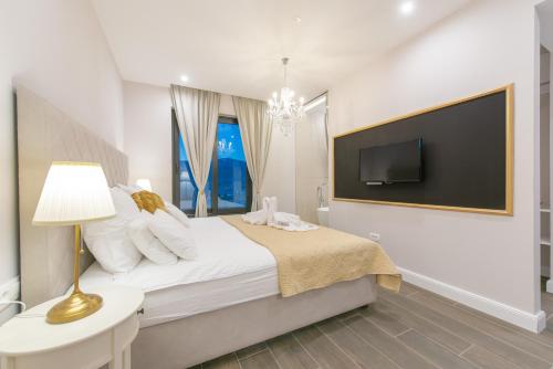 a bedroom with a bed and a tv on a wall at Samstag Split in Split