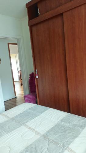 a bedroom with a bed and a wooden door at Casa en Viña del Mar in Viña del Mar