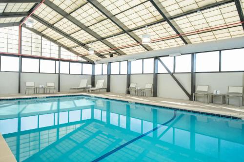 a large swimming pool with blue water at Hyatt Place Denver-South/Park Meadows in Lone Tree