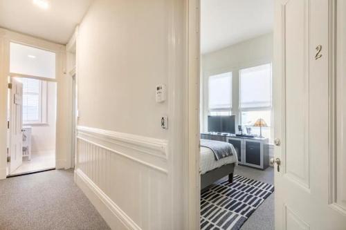 a white bedroom with a bed and a window at Pacific Heights Victorian Bedroom and Bathroom in San Francisco