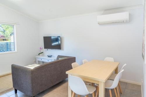 a living room with a table and a couch at Ingenia Holidays Noosa in Tewantin
