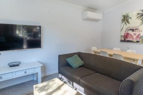 a living room with a couch and a table at Ingenia Holidays Noosa in Tewantin