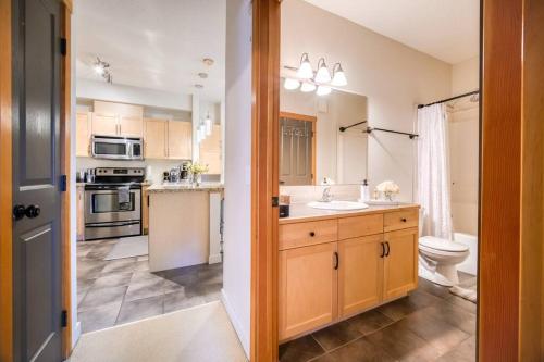 a kitchen with a sink and a toilet in it at Mountain Escape sleeps 10 Guests in this 3BD 2BT Top Floor Condo with Mountain View in Canmore