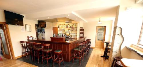 a bar in a restaurant with stools at Moran's Bar & B&B in Grange