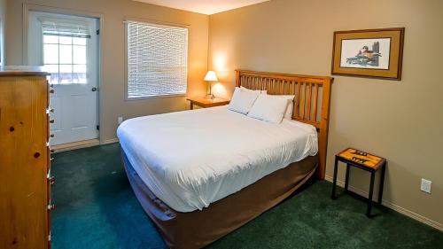 a bedroom with a large bed and a window at Polar Peak Chalet by Fernie Lodging Company in Fernie