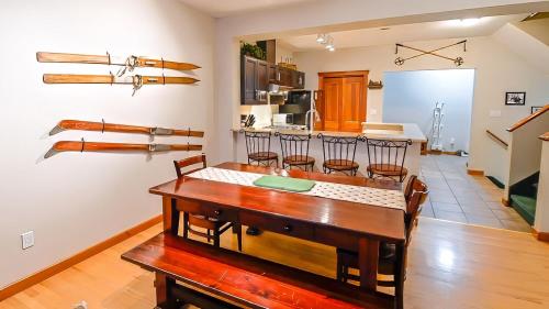 a dining room with a table and a kitchen at Polar Peak Chalet by Fernie Lodging Company in Fernie