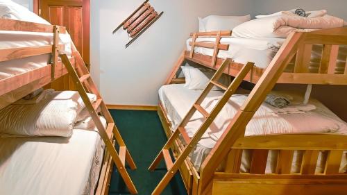 a group of bunk beds in a room at Polar Peak Chalet by Fernie Lodging Company in Fernie
