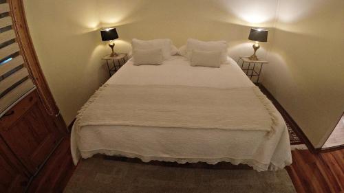 a bedroom with a bed with white sheets and pillows at Hotel Boutique Terra Diaguita & Spa in La Serena