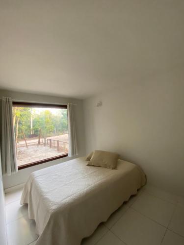 Un pat sau paturi într-o cameră la Chalé Oxente em Corumbau-BA