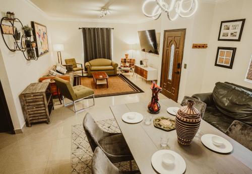 a living room with a table and chairs and a living room at Casa Panda near Airport / Shopping Plaza and International Border in Tijuana