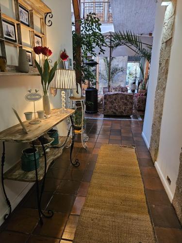 a hallway with a table and flowers on a tiled floor at Hotel Boutique Terra Diaguita & Spa in La Serena