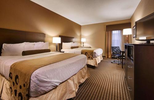 a hotel room with two beds and a television at Best Western Plus Mishawaka Inn in South Bend