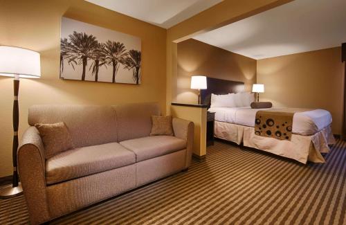 a hotel room with a couch and a bed at Best Western Plus Mishawaka Inn in South Bend