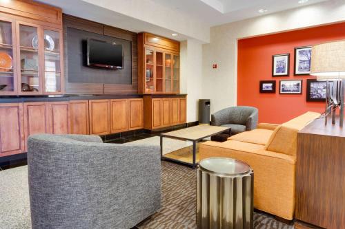 a hotel room with a bed and a tv at Drury Inn & Suites Greenville in Greenville