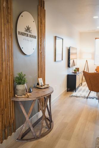 a hallway with a table with a harper house sign on a wall at Harper House in Santa Clara