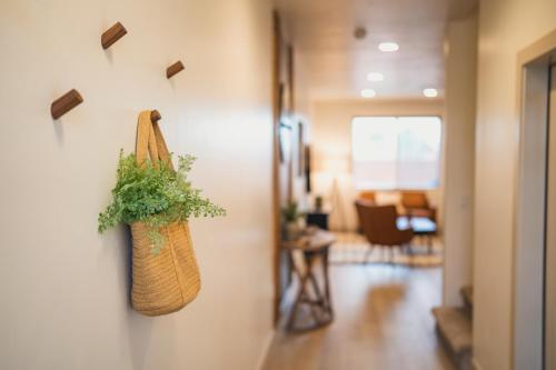 a purse hanging on a wall in a hallway at Harper House in Santa Clara