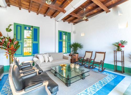a living room with a couch and chairs and a table at Casa Cedrela Hotel Boutique by HMC -Cauca Viejo- Mayores de 14 años in Jericó