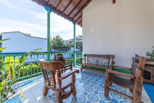 a porch with chairs and a swimming pool at Casa Cedrela Hotel Boutique by HMC -Cauca Viejo- Mayores de 14 años in Jericó