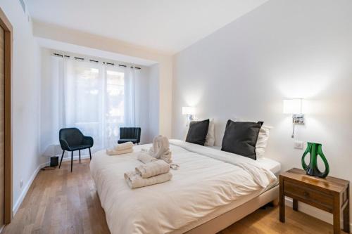 - une chambre blanche avec un grand lit et des serviettes dans l'établissement Wonderful 2 bedroom apartment, à Cannes