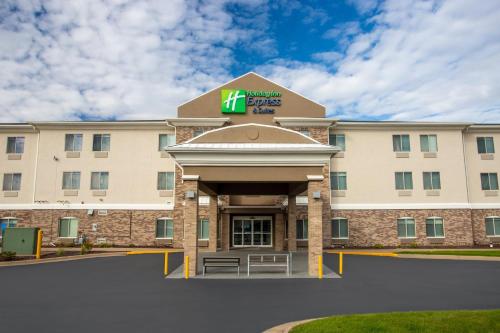 a hotel with a sign on the front of it at Holiday Inn Express & Suites Clinton by IHG in Clinton