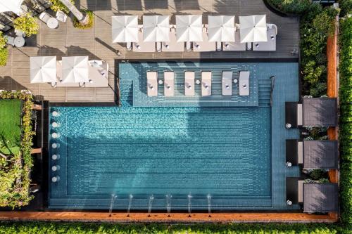an overhead view of a swimming pool with umbrellas at InterContinental Chiang Mai The Mae Ping, an IHG Hotel in Chiang Mai