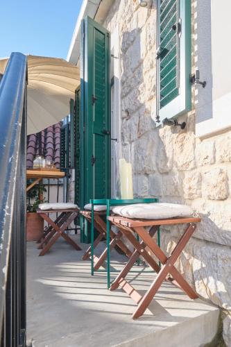 a couple of picnic tables sitting outside of a building at Heritage House in Historic Center of Split in Split