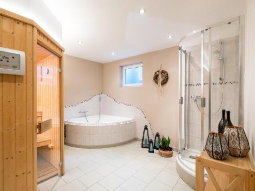 a large bathroom with a tub and a shower at Seebach in Krimml