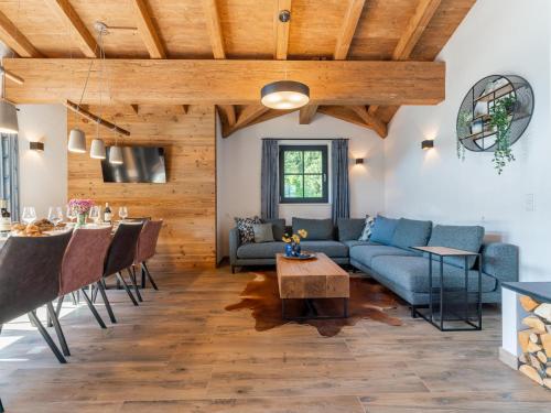 a living room with a couch and a table at Chalet Joep in Wald im Pinzgau