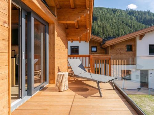 a wooden deck with a bench on the side of a house at Chalet Joep in Wald im Pinzgau