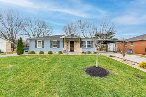 a house with a tree in the middle of a yard at Family-Friendly Home with Yard 27 Mi to Nashville! in Springfield