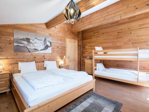 two bunk beds in a room with wooden walls at Seebach in Krimml