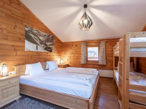 a bedroom with a bed and two bunk beds at Waldberg in Krimml