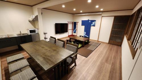 a dining room with a table and a blue cross on the wall at Hida Takayamasan no machi House - Vacation STAY 98088v in Takayama