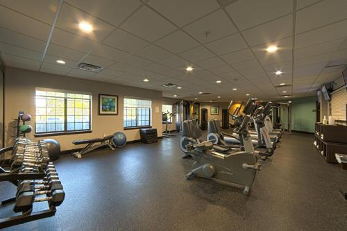 a gym with several treadmills and machines in a room at Staybridge Suites Houston-NASA Clear Lake by IHG in Webster