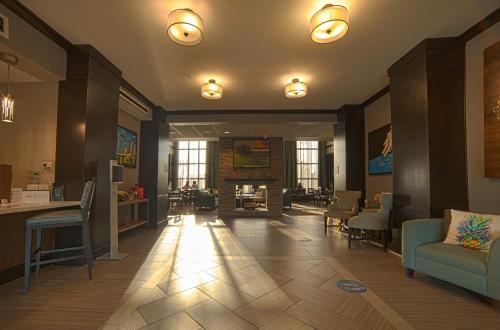a lobby with chairs and a fireplace in a building at Staybridge Suites Houston-NASA Clear Lake by IHG in Webster