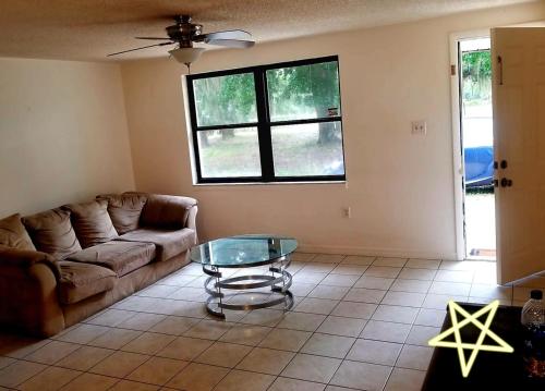 a living room with a couch and a glass table at boats,horses & RV parking in Wimauma