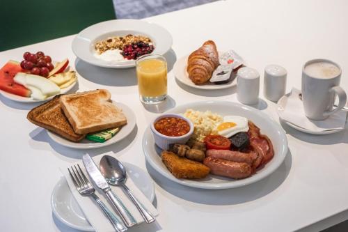 a table with plates of breakfast food on it at Holiday Inn Doncaster A1- M Jct 36 by IHG in Doncaster