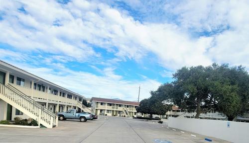 a car parked in a parking lot next to a building at Soledad Motel 8 in Soledad