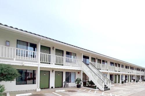 a building with a staircase on the side of it at Soledad Motel 8 in Soledad